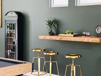 Bar shelf with decorative items and bar stools
